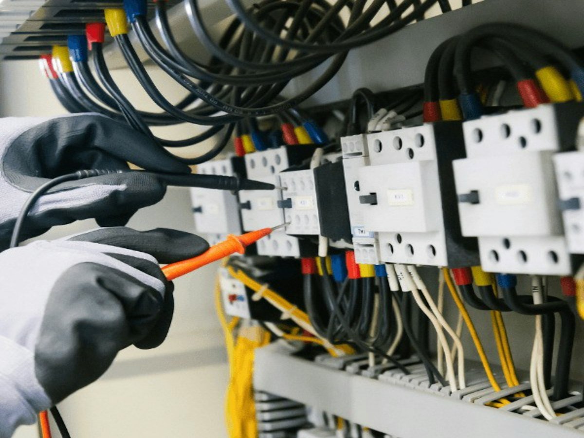 Electrician testing a panel